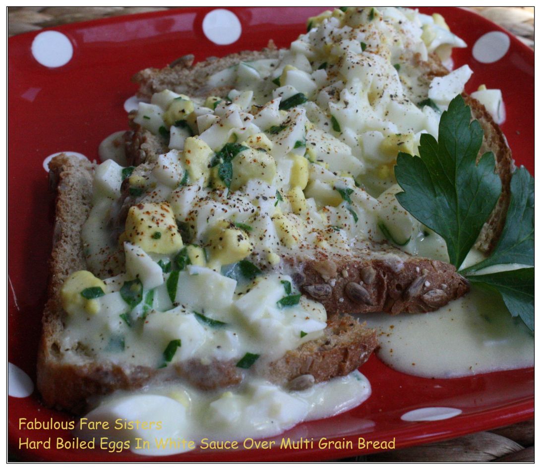 Hard Boiled Eggs In White Sauce Over Multi Grain Bread